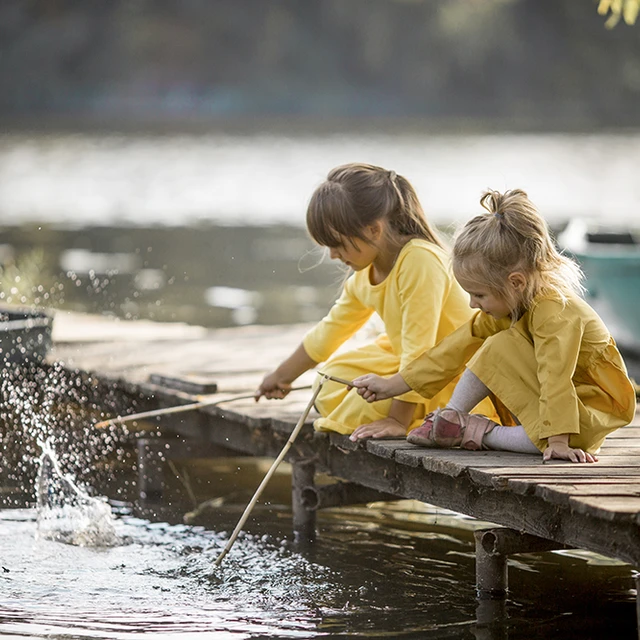 kids playing by a lake