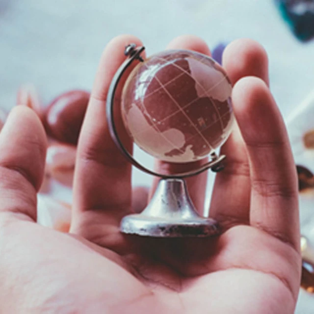 hand holding a globe