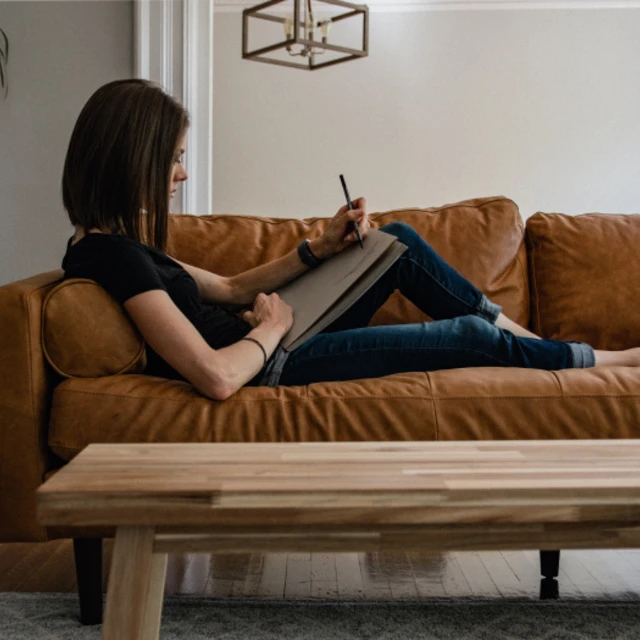 women sitting in leather couch