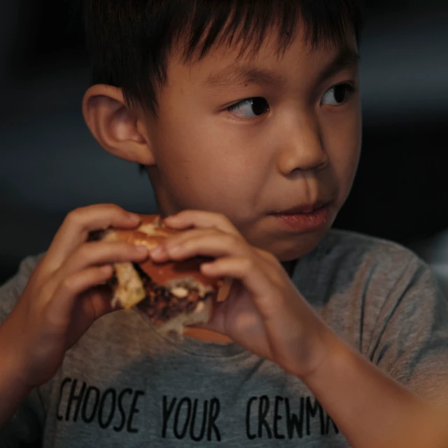 Boy enjoying plant-based burger