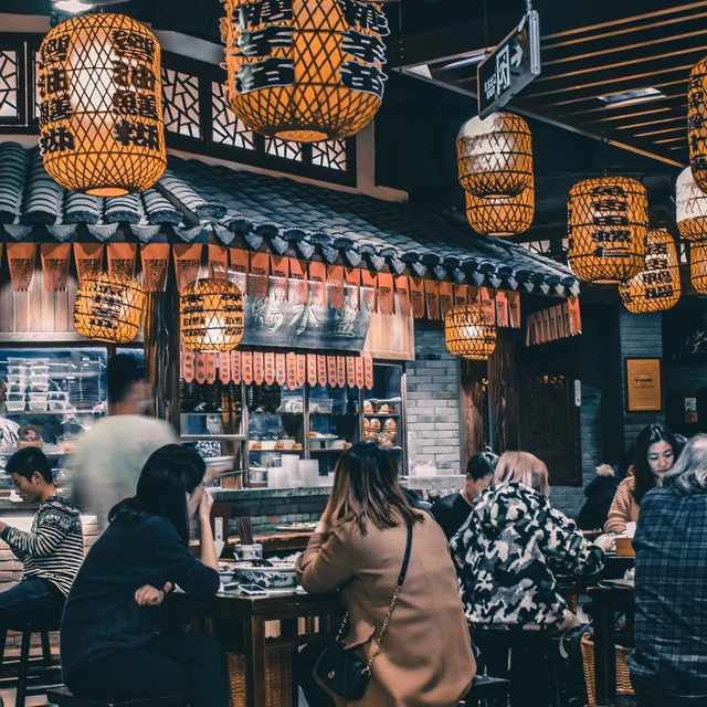 group of people sitting on chairs in a restaurant