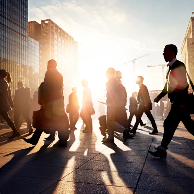 people walking with the sun in the background