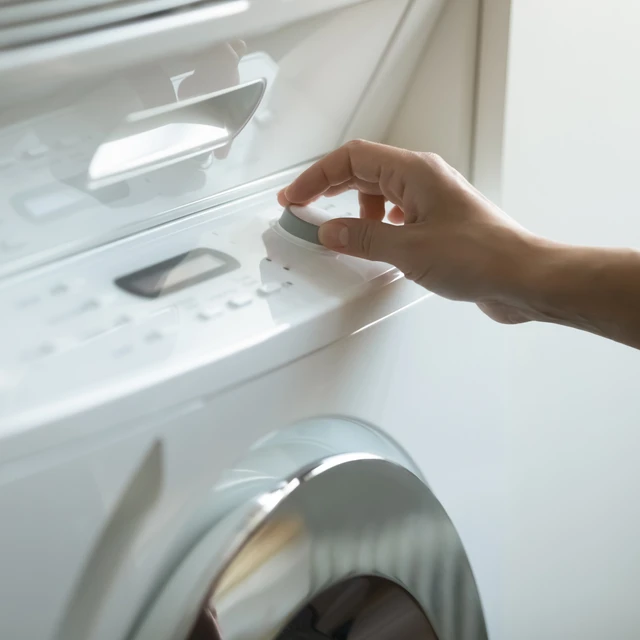 Consumer turning down the temperature on washing machine to reduce footprint