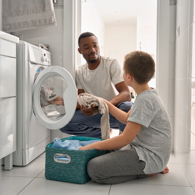 Father and son doing laundry