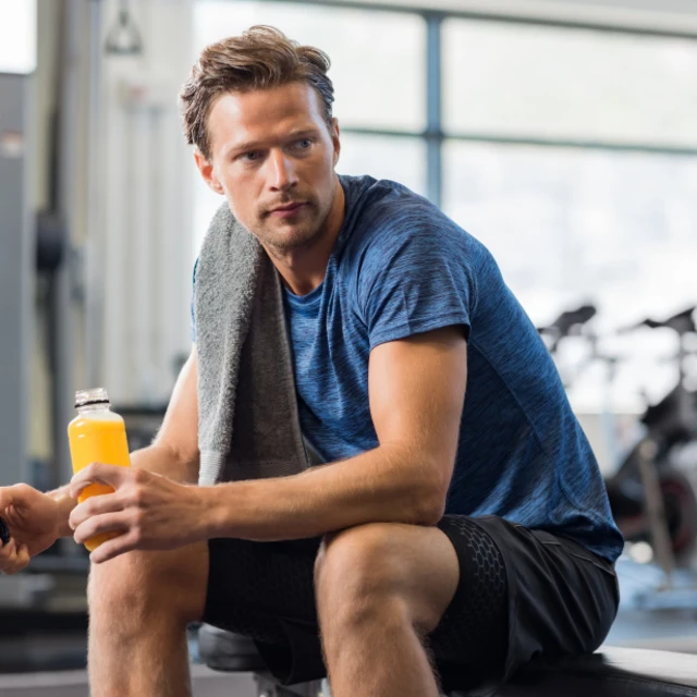 Man in gym drinking energy drink