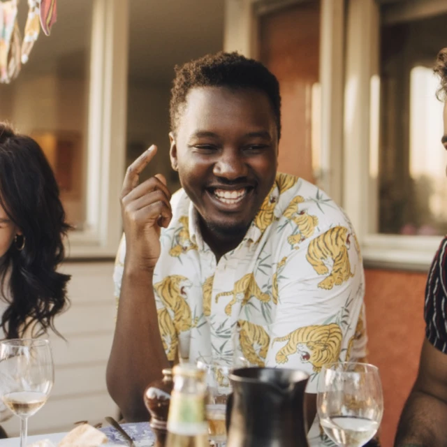 Man smiling and spending time with his friends