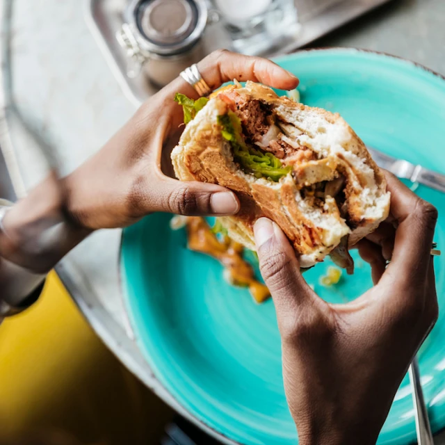 Person eating a plant-based burger