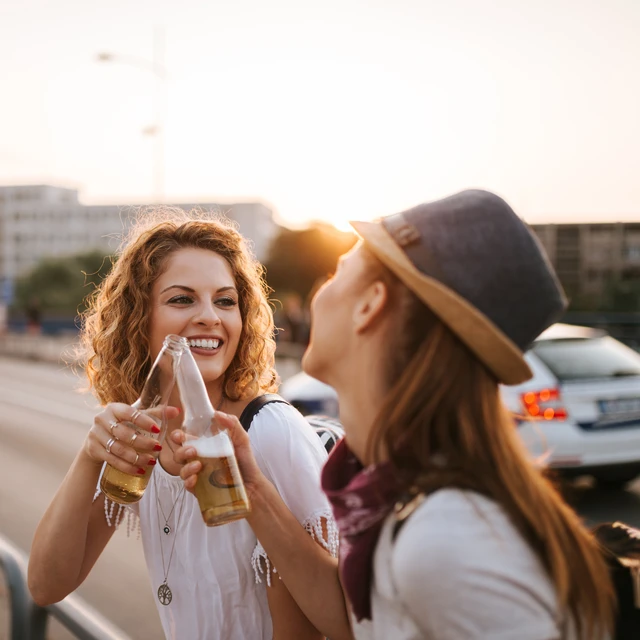 Two young women enjoying a beer