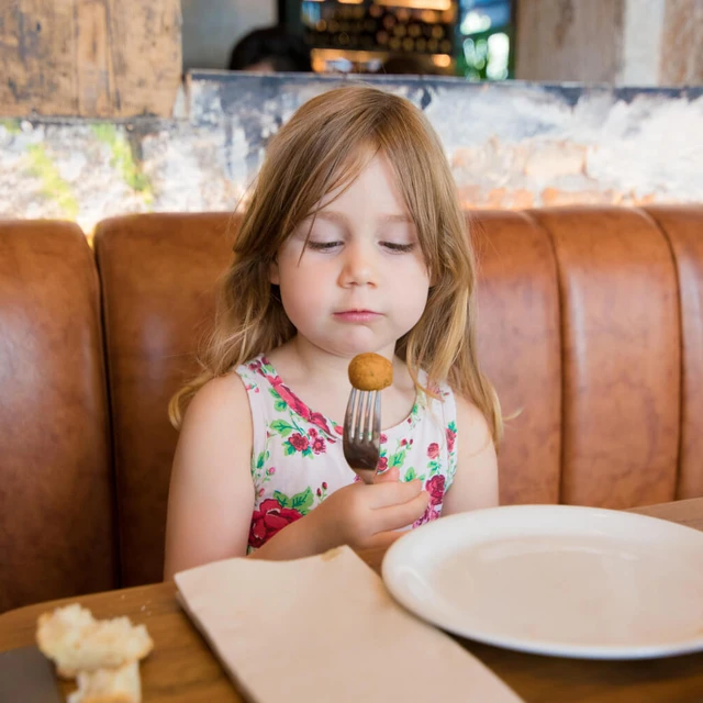 Girl eating croquettes