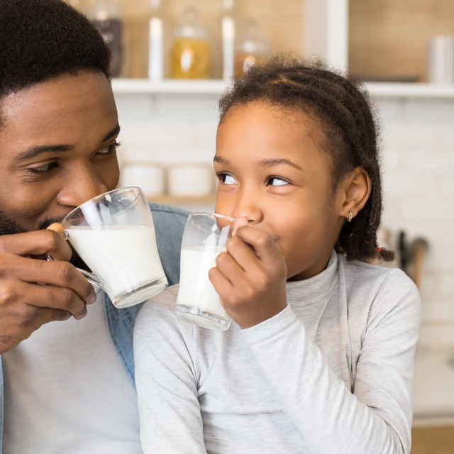 father and daughter with milk glasses