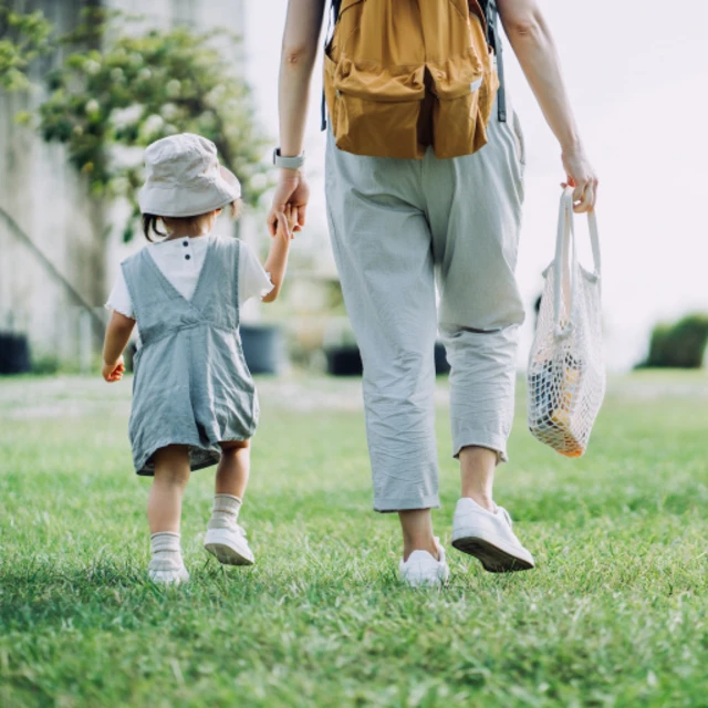 girl walking with her mum in a park