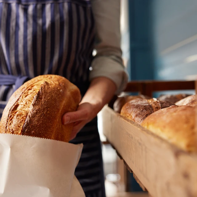 Baker packing freshly baked bread