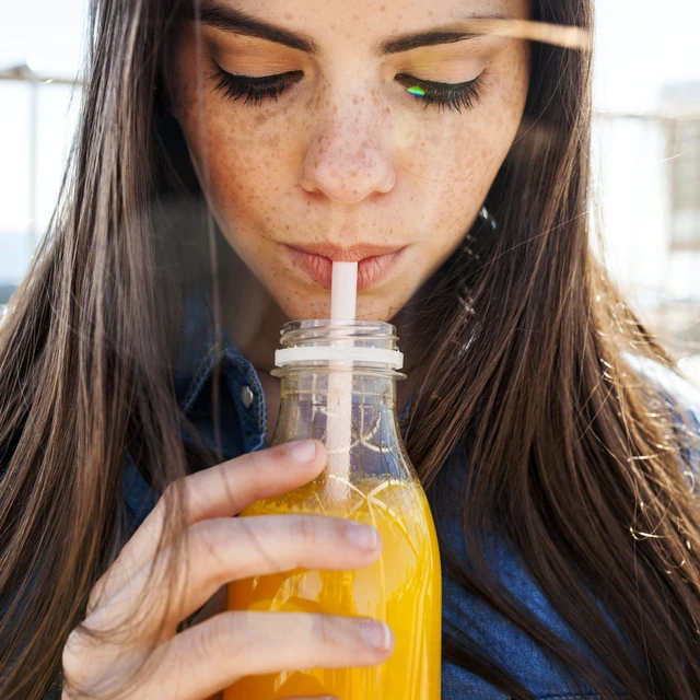 Girl drinking orange juice