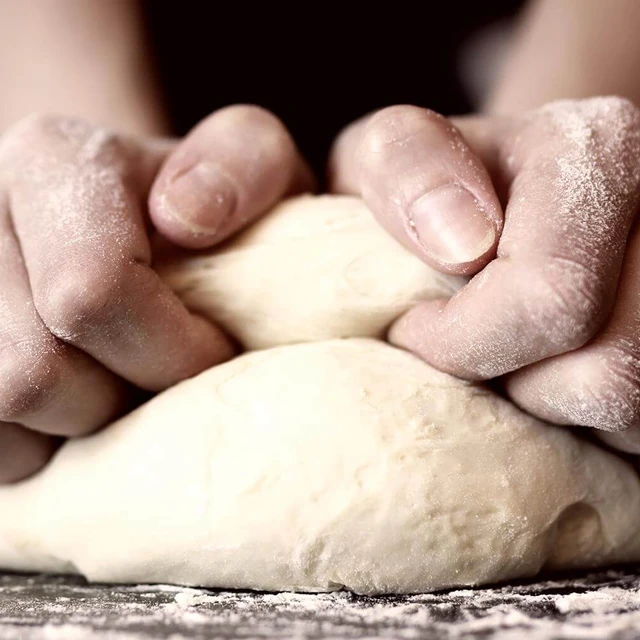 baker kneeding dough