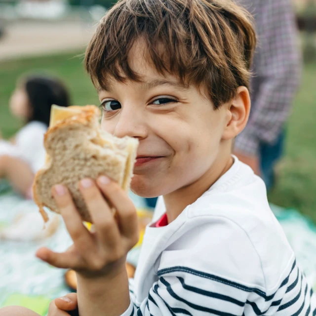 Boy enjoying the first bite of his sandwich