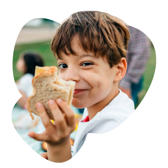 Boy enjoying the first bite of his sandwich