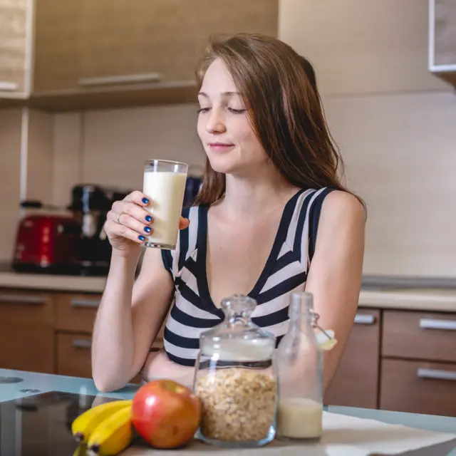 Woman drinking oat drink