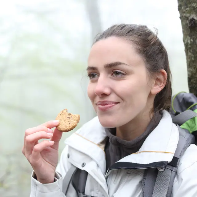 Hiker eating healthy biscuit