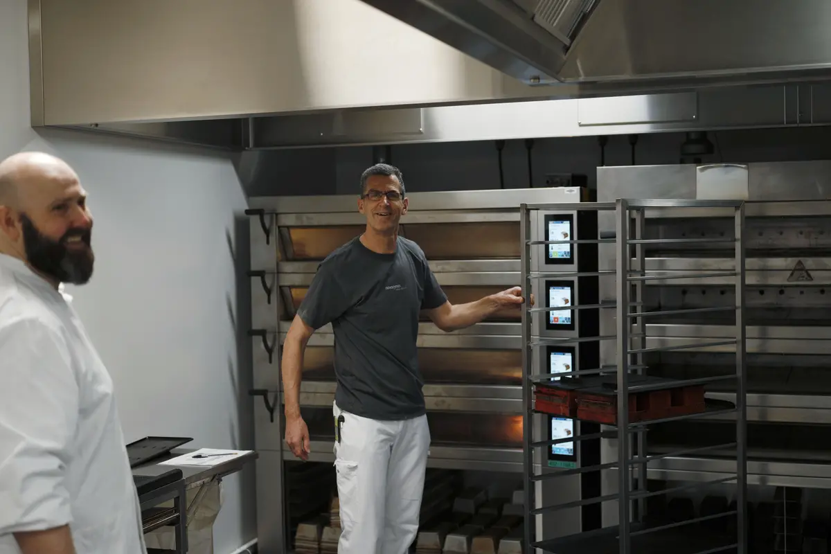 baker standing beside Industrial oven