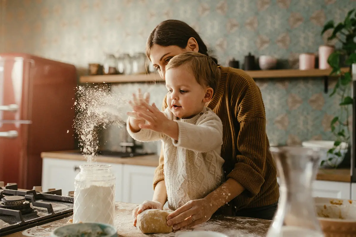 mother and baby baking bread