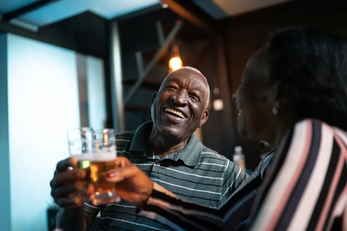 Elder man enjoying his favourite quality beer with his spouse