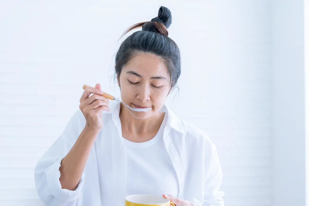 Woman feeling plant-based vogurt texture