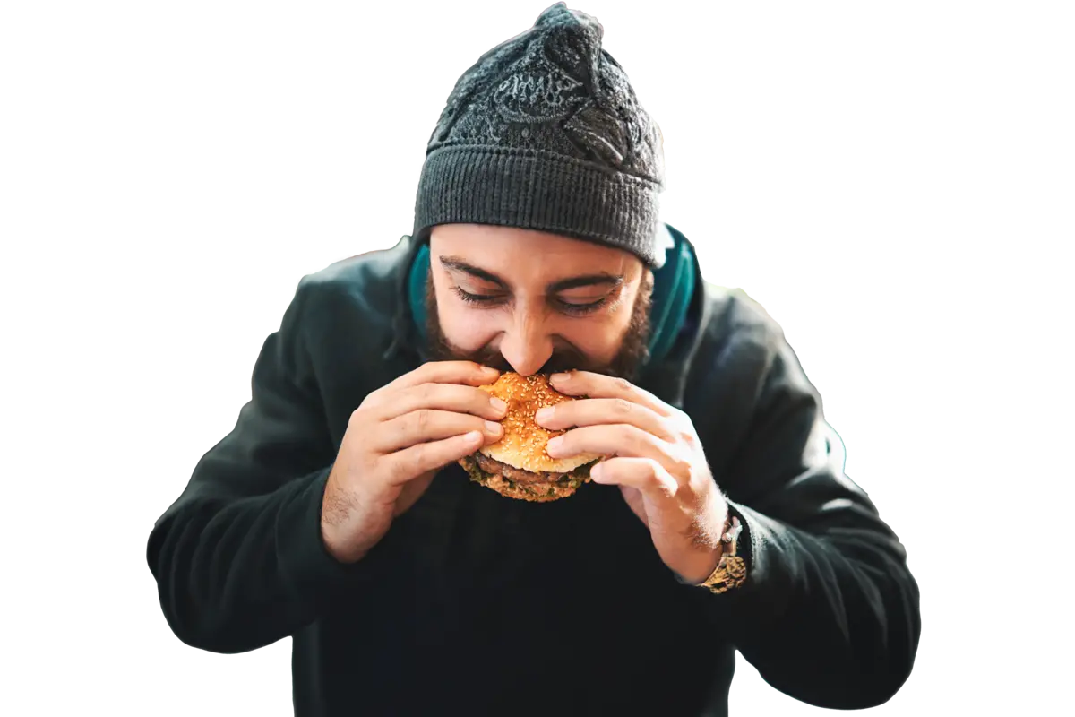 Man eating a plant-based burger and enjoying the sensory experience one bite at a time