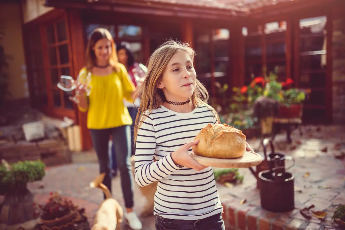 girl holding a new baked bread