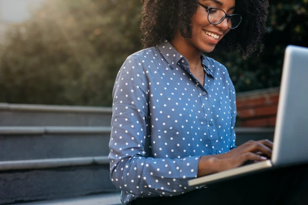 women sitting with a laptop