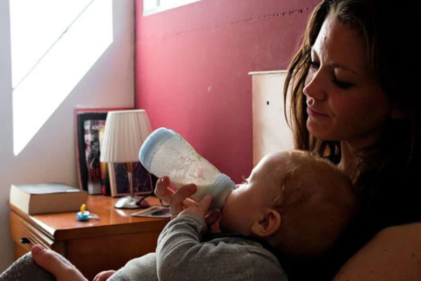 woman feeding a infant