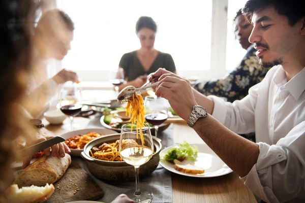 Familiy enjoying a pasta dish