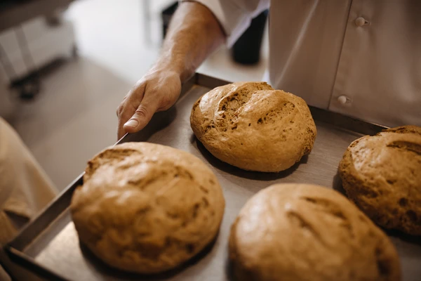 Industrial baker with freshly baked bread