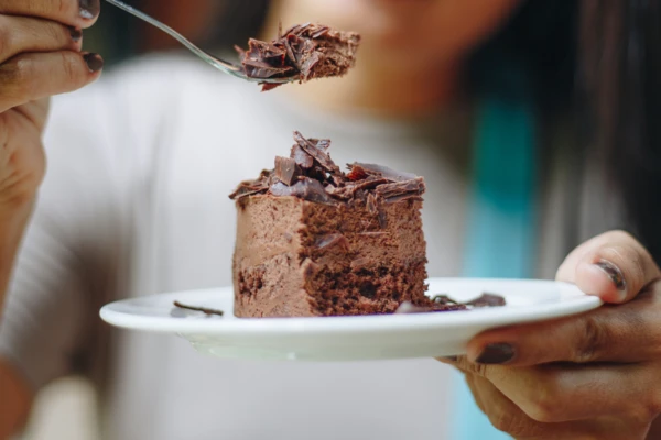 Woman enjoying soft and moist cake