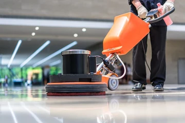 Cleaning worker cleaning floor in an officespace