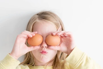 Girl holding two eggs
