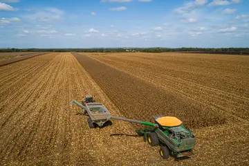 farming field with trackers harvesting crops
